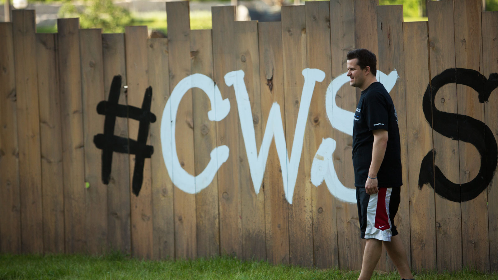 Man in Front of CWS Sandlot Fence