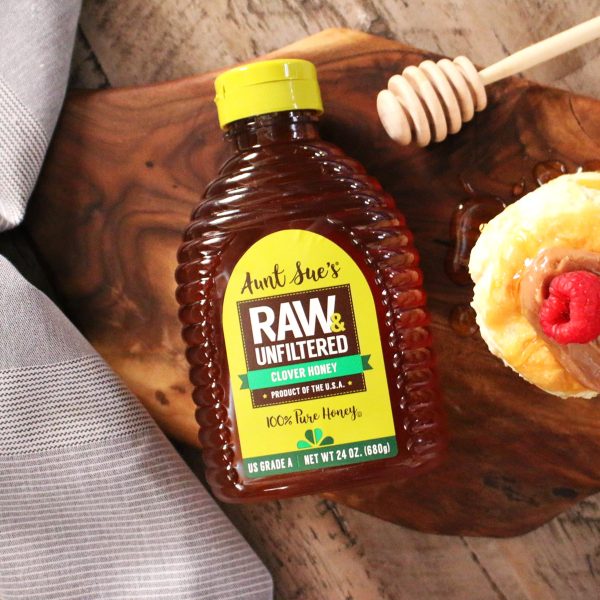 Aunt Sue's Raw & Unfiltered Honey Bottle with a Pastry